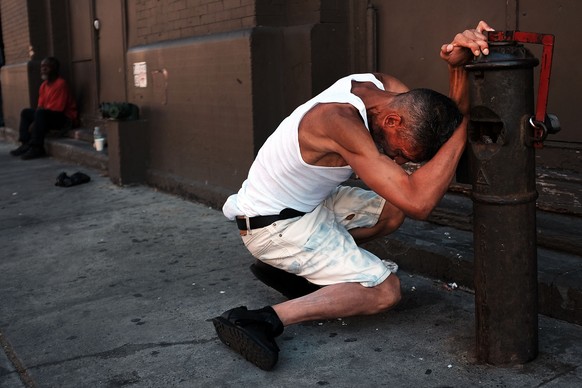 NEW YORK, NY - AUGUST 28: A man pauses while high on K2 or &#039;Spice&#039;, a synthetic marijuana drug, along a street in East Harlem on August 28, 2015 in New York City. New York, along with other  ...