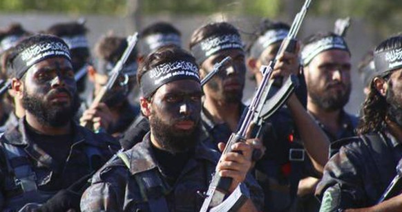 In this image posted on the Twitter page of Ahrar al-Sham on June. 19, 2015, fighters from Ahrar al-Sham march in the eastern Damascus suburb of Ghouta, Syria. Unlike the Islamic State group and al-Qa ...