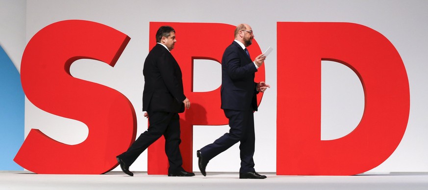 German Economy Minister and Leader of the Social Democratic Party (SPD) Sigmar Gabriel (L) and European Parliament President Martin Schulz walk on the podium during the SPD party congress in Berlin, G ...