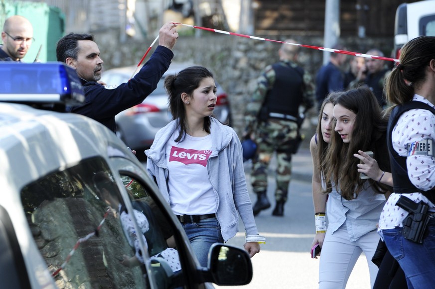 epa05852301 Police forces let girls walk off the scene of a shooting at Lycee Alexis de Tocqueville school in Grasse, near Cannes, southern France, 16 March 2017. According to reports, several people  ...