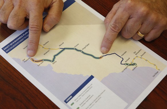 Dan Richard, chairman of the board that oversees the California High-Speed Rail Authority, gestures to a map showing the proposed initial construction of the bullet train in the revised business plan, ...