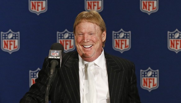 Oakland Raiders owner Mark Davis smiles as he steps up to the podium during a news conference after NFL football owners approved the move of the Raiders to Las Vegas in a 31-1 vote at the NFL meetings ...