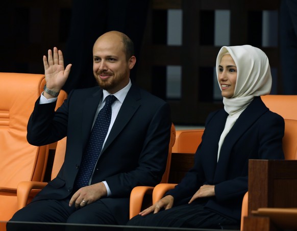 Recep Tayyip Erdogan&#039;s son, Bilal Erdogan, left, and daughter, Sumeyye Erdogan, smile as their father takes the oath of office at the parliament in Ankara, Turkey, Thursday, Aug. 28, 2014. Erdoga ...