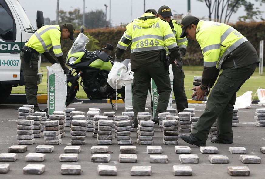 Police unpack bags of seized cocaine as they display it to the press at the police station in Bogota, Colombia, Thursday, Sept. 8, 2016. The National Director of Traffic and Transport Gen. Ramiro Cast ...