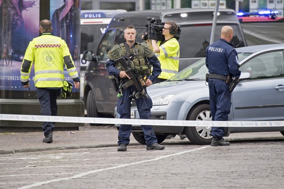 epaselect epa06150296 Police officers gather at the site of a multiple stabbing on the Market Square in Turku, Finland, 18 August 2017. According to police reports on 18 August, two people were killed ...