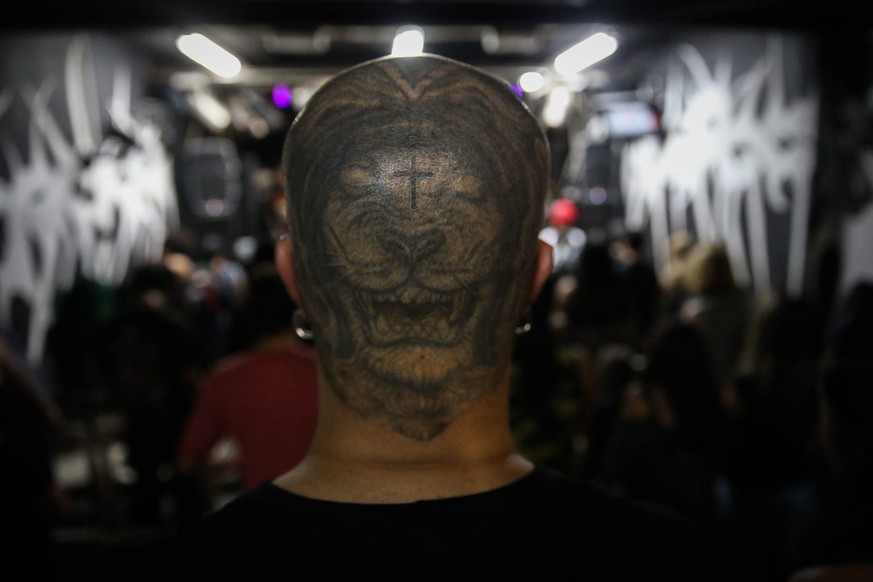 epa05713345 A picture available on 12 January 2017 shows the hair cut of a man during worship at the Crash Church in Sao Paulo, Brazil, 08 January 2017. In a garage in Sao Paulo, with the aesthetic of ...