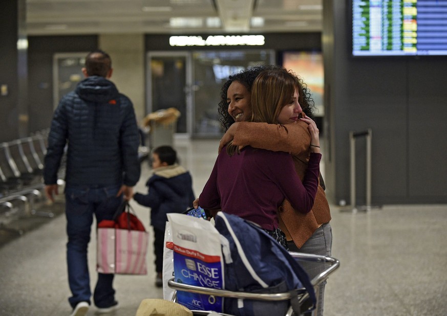 epa05773299 Roslyn Sinha (R), 30, hugs her immigration attorney Elinor K. Tesfanariam, who has been volunteering and offering legal help at Dulles International Airport in Sterling, Virginia, USA, 05  ...