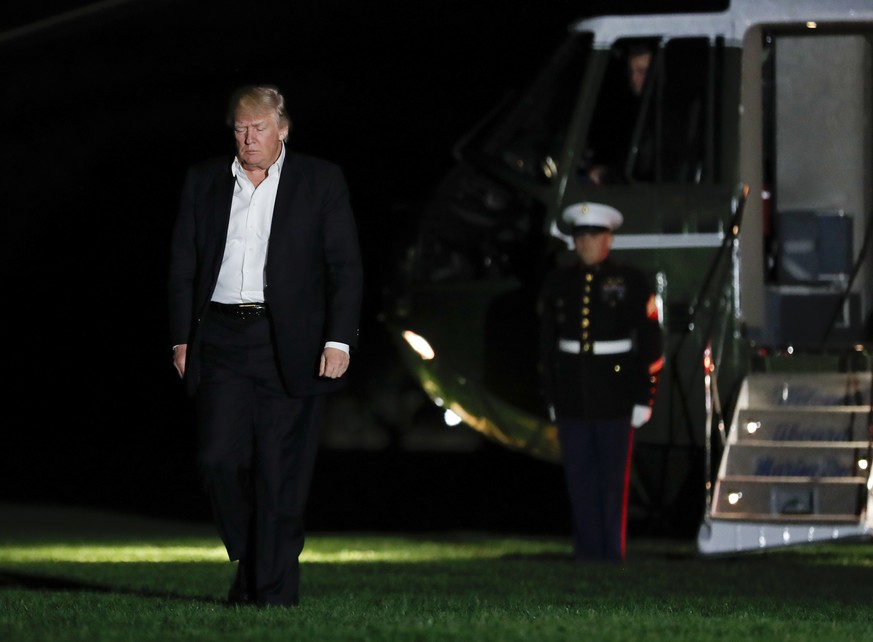 President Donald Trump walks from Marine One across the South Lawn to the White House in Washington, Sunday, May 7, 2017, as he returns from Trump National Golf Club in Bedminster, N.J. (AP Photo/Caro ...