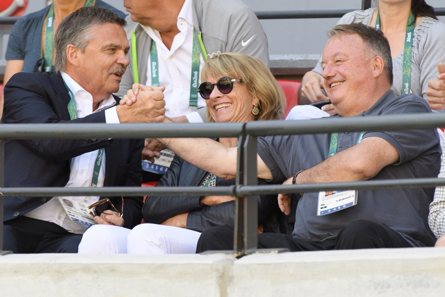 The president of the Swiss Tennis Federation, Rene Stammbach, right, cheers with IOC member and President of the International Ice Hockey Federation, Swiss Rene Fasel during the women&#039;s doubles g ...