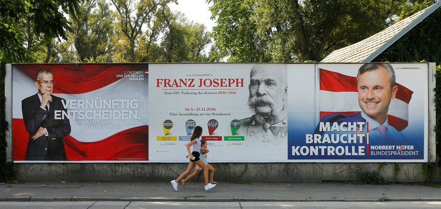 An exhibition advertisement on the occasion of the 100th anniversary of the death of former Austrian Emperor Franz Joseph is seen betweeen presidential election campaign posters of Alexander Van der B ...