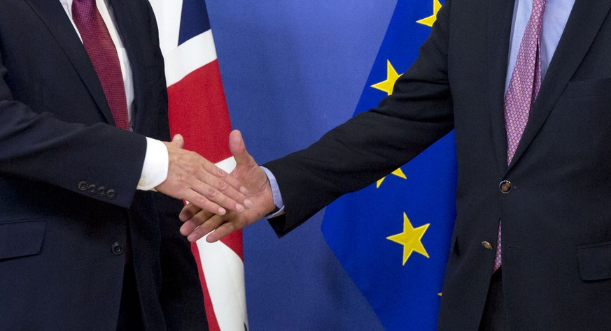 EU Chief Brexit Negotiator Michel Barnier, right, and British Secretary of State David Davis shake hands as they arrive at EU headquarters in Brussels on Monday, June 19, 2017. Brexit negotiators will ...