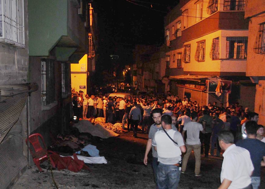 People gather after an explosion in Gaziantep, southeastern Turkey, early Sunday, Aug. 21, 2016. Gaziantep Province Gov. Ali Yerlikaya said the deadly blast, during a wedding near the border with Syri ...