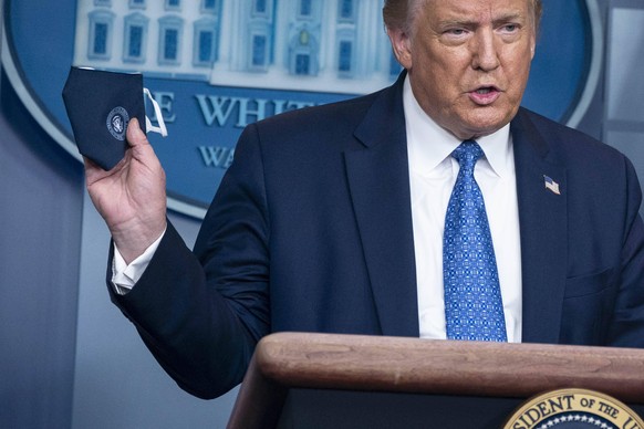 July 22, 2020, Washington, District of Columbia, USA: United States President Donald J. Trump holds a face mask during a news conference at the White House in Washington, D.C., U.S., on Wednesday, Jul ...