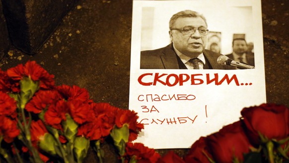 epa05682729 Flowers lie near a picture of Russia&#039;s ambassador to Turkey Andrei Karlov outside the Russian foreign ministry in Moscow, Russia, 19 December 2016. Russia&#039;s ambassador to Turkey, ...