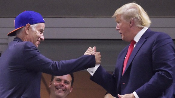 epa04921237 Republican presidential hopeful Donald Trump (R) shakes hands with US teennia great John McEnroe (L) as Venus Williams of the US plays Serena Williams of the US during their quarterfinals  ...