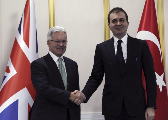 Turkey&#039;s EU Minister Omer Celik, right, and British Minister of State for Foreign and Commonwealth Affairs, Alan Duncan, shake hands prior to a meeting in Ankara, Turkey, Wednesday, Oct. 19, 2016 ...