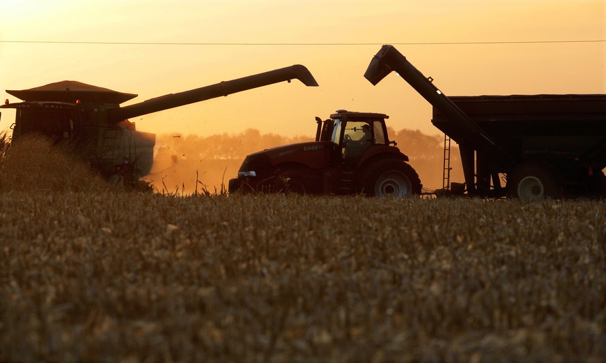 Central Illinois farmers continue to harvest their corn crops as the sun sets Monday, Oct. 17, 2016, in Berlin, Ill. The corn and soybean harvests are well underway in the Midwest and helped by excell ...