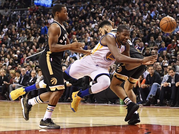 Golden State Warriors forward Kevin Durant (35) is fouled by Toronto Raptors guard Kyle Lowry (7) as Raptors guard Cory Joseph (6) defends during the second half of an NBA basketball game Wednesday, N ...