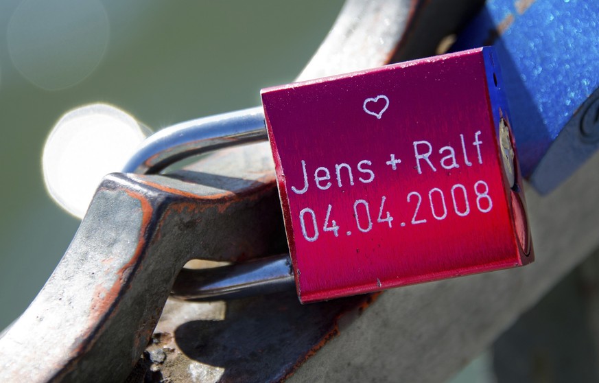 FILE - In this Sept. 30, 2013 file photo a so-called ove lock with two engraved male names sits at a fence near the Masch lake in Hannover, Germany. German parliament will vote on Friday&lt; June 30,  ...