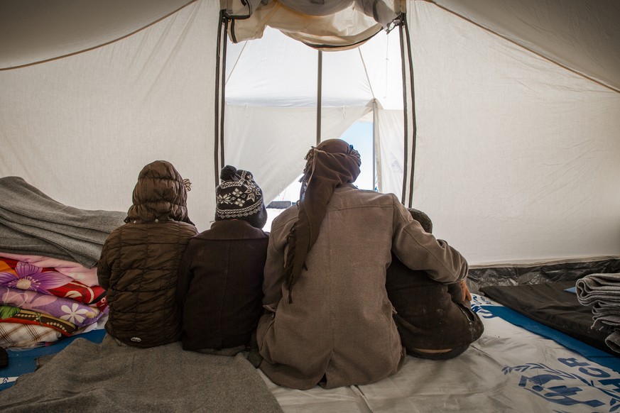 Kareem*, an Iraqi father from Mosul, sits with his children in their tent in Al Hol Camp in Hasakah Governorate, Syria. Kareem arrived in Al Hol Camp with his wife and five children three days earlier ...