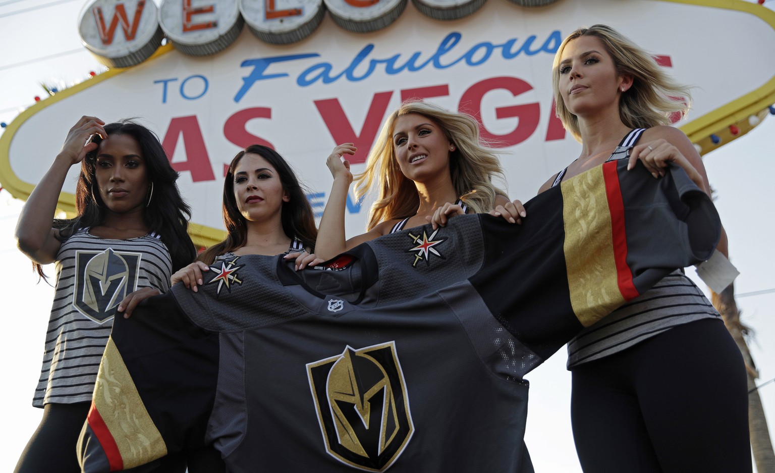 Models unveil the Vegas Golden Knights&#039; new hockey jersey Tuesday, June 20, 2017, in Las Vegas. The Knights are an NHL hockey expansion team. (AP Photo/John Locher)