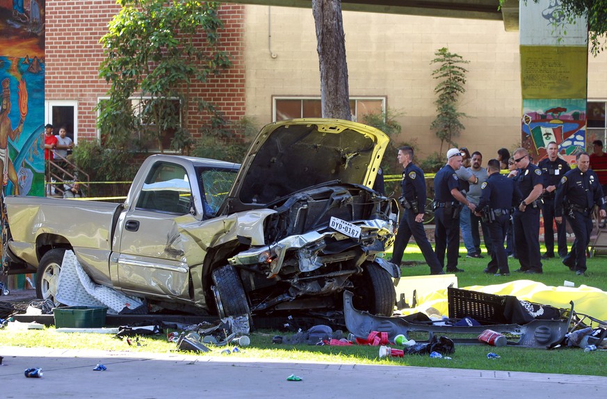 Police stand near the pickup truck that landed at Chicano Park after it flew off a ramp to the San Diego Coronado Bridge in San Diego on Saturday, Oct. 15, 2016. Four people were killed and nine were  ...