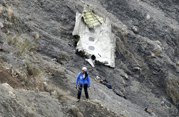 epa05208963 (FILE) A file photograph showing a search and rescue worker at the crash site of the Germanwings Airbus A320 that crashed in the French Alps, above the town of Seyne-les-Alpes, southeaster ...