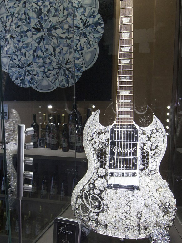 epa05824531 A visitor looks at a diamond encrusted guitar on display at the Hong Kong International Jewellery Show, which features diamond traders and fine jewellery companies, in Hong Kong, China, 02 ...