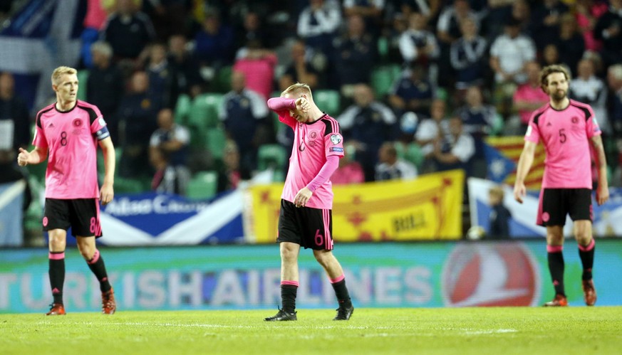 Scotland&#039;s Barry Bannan, center, reacts after Slovenia scored their second goal during the World Cup Group F qualifying soccer match between Slovenia and Scotland, at the Stozice stadium in Ljubl ...