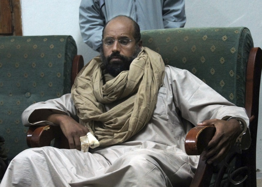 FILE - In this Nov. 19, 2011, file photo, Seif al-Islam is seen after his capture in the custody of revolutionary fighters in Zintan, a town south of the capital Tripoli, Libya. A statement by his cap ...