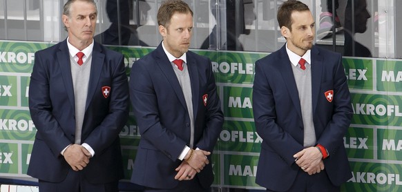 Patrick Fischer, right, head coach of Switzerland national ice hockey team, with assistants coach Felix Hollenstein, left, and Reto von Arx, center, look on disappointed after loosing against Czech Re ...