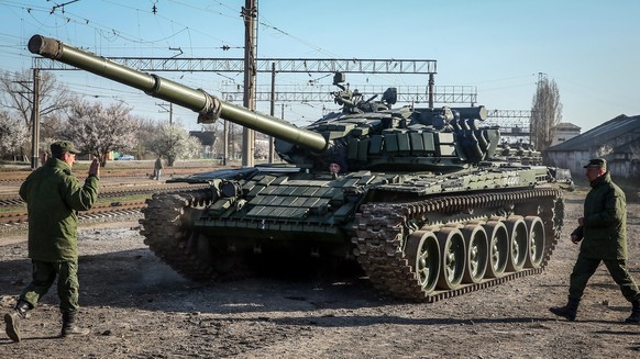 epa04148690 Russian soldiers unload the new modified Russian T-72 tanks from railway platforms on the railway station in Gvardeyskoe village near Simferopol, Crimea, Ukraine, 31 March 2014. The new ta ...