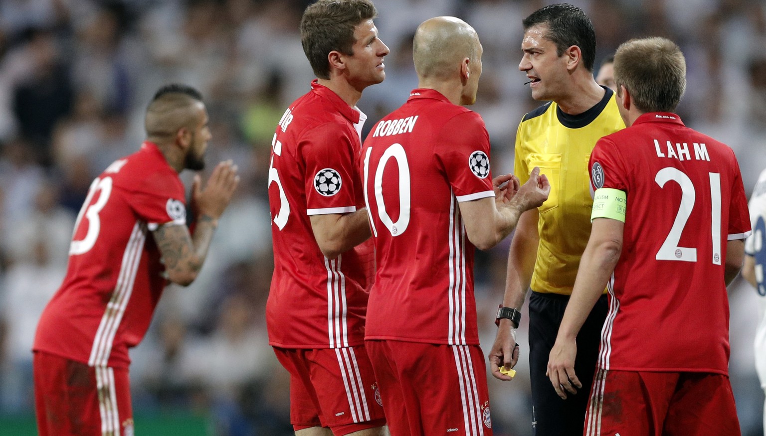 Bayern players argue with Referee Viktor Kassai after he showed a second yellow card to Arturo Vidal, left, during the Champions League quarterfinal second leg soccer match between Real Madrid and Bay ...