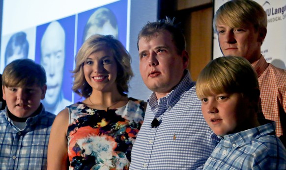 Former Mississippi firefighter Patrick Hardison, 42, center, is surrounded with his children Braden, 13, far left, Allison, 21, second from left, Cullen, 12, far right, and Dalton, 18, second from rig ...