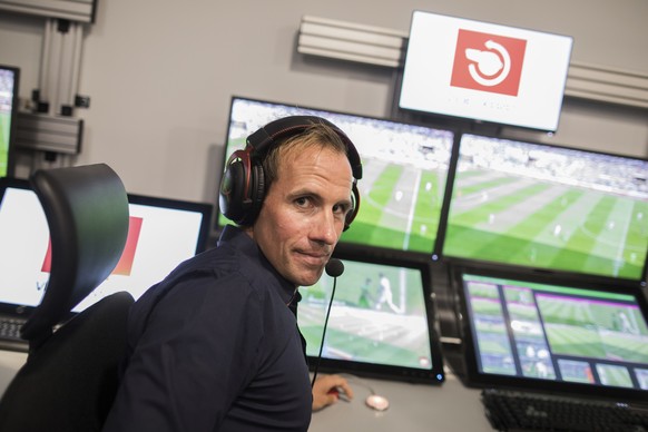 In this July 20, 2017 photo, referee Sascha Stegemann sits in front of screens showing match sequences in a video assistant referee center in Cologne, Germany. With the beginning of the new German Bun ...