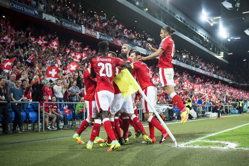 epa05527611 Swiss players celebrate their opening goal during the FIFA World Cup 2018 group B qualifying soccer match between Switzerland and Portugal at the St. Jakob-Park stadium in Basel, Switzerla ...