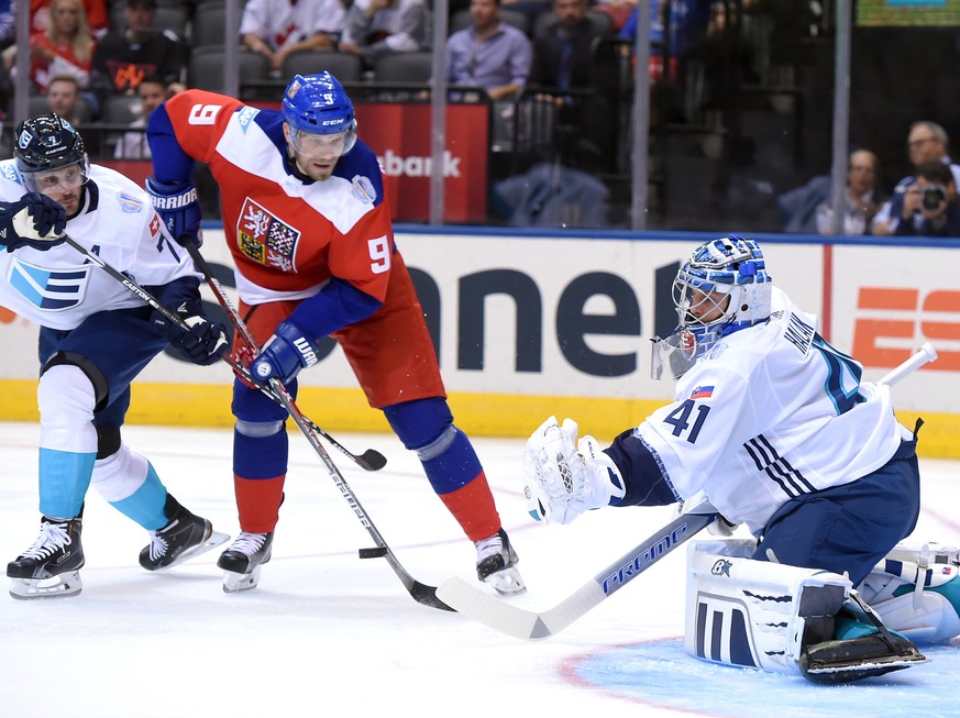 Sep 19, 2016; Toronto, Ontario, Canada; Czech Republic forward Milan Michalek (9) fends off Team Europe defenceman Mark Streit (7) as he tries to tip the puck past goalie Jaroslav Halak (41)during pre ...