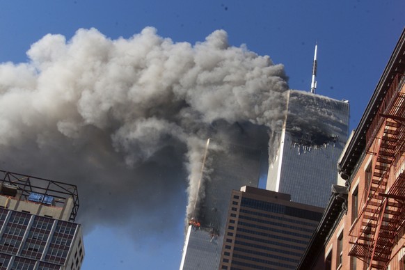 FILE - In this Sept. 11, 2001 file photo, smoke rising from the burning twin towers of the World Trade Center after hijacked planes crashed into the towers, in New York City. Every American of a certa ...