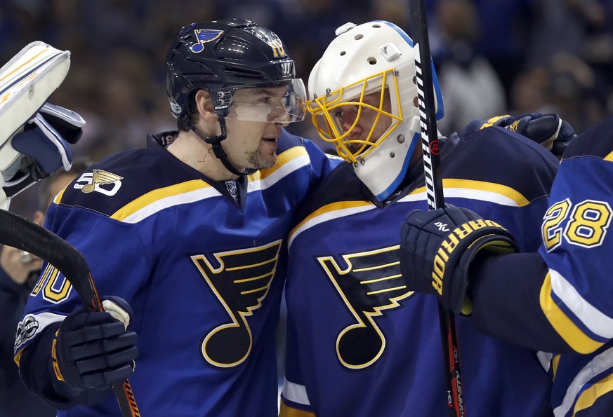 St. Louis Blues goalie Jake Allen, right, celebrates with Scottie Upshall after the Blues&#039; 3-1 victory over the Minnesota Wild in Game 3 of an NHL hockey first-round playoff series, Sunday, April ...