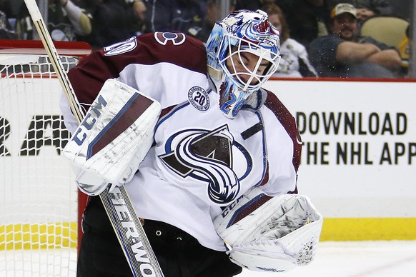Colorado Avalanche goalie Reto Berra (20) stops a shot during the second period of an NHL hockey game against the Pittsburgh Penguins in Pittsburgh Thursday, Nov. 19, 2015. (AP Photo/Gene J. Puskar)