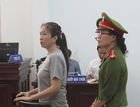 Prominent blogger Nguyen Ngoc Nhu Quynh, left, stands trial in the south central province of Khanh Hoa, Vietnam, Thursday, June 29, 2017. She was accused of distorting government policies and defaming ...
