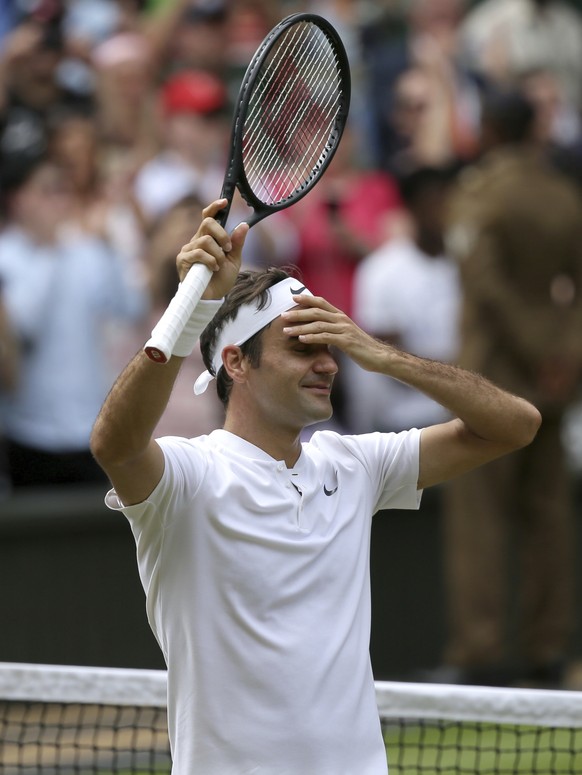 Switzerland&#039;s Roger Federer celebrates after defeating Croatia&#039;s Marin Cilic, left, to win the Men&#039;s Singles final match on day thirteen at the Wimbledon Tennis Championships in London  ...