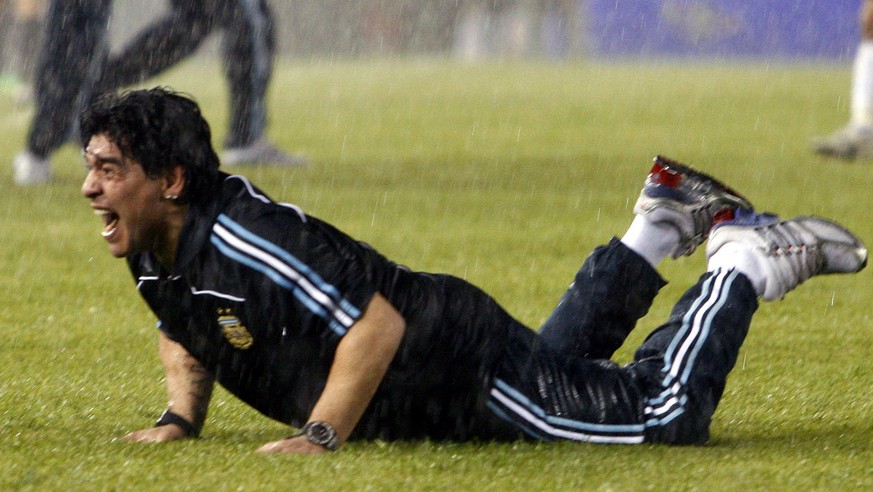 Under pouring rain, Argentina&#039;s coach Diego Maradona celebrates at the end of a 2010 World Cup qualifying soccer match against Peru in Buenos Aires, Saturday, Oct. 10, 2009. Argentina won 2-1. (A ...