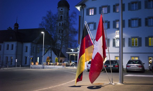 A German and a Swiss flag indicate the way to the networking event of the Swiss German Club&#039;s central Switzerland section at Hotel Kreuz in Sachseln in the Canton of Obwalden, Switzerland, pictur ...