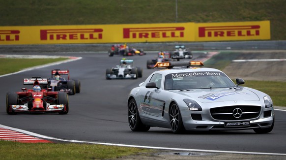 Ferrari Formula One driver Fernando Alonso of Spain (L) follows a safety car during the Hungarian F1 Grand Prix at the Hungaroring circuit, near Budapest July 27, 2014. REUTERS/Laszlo Balogh (HUNGARY  ...