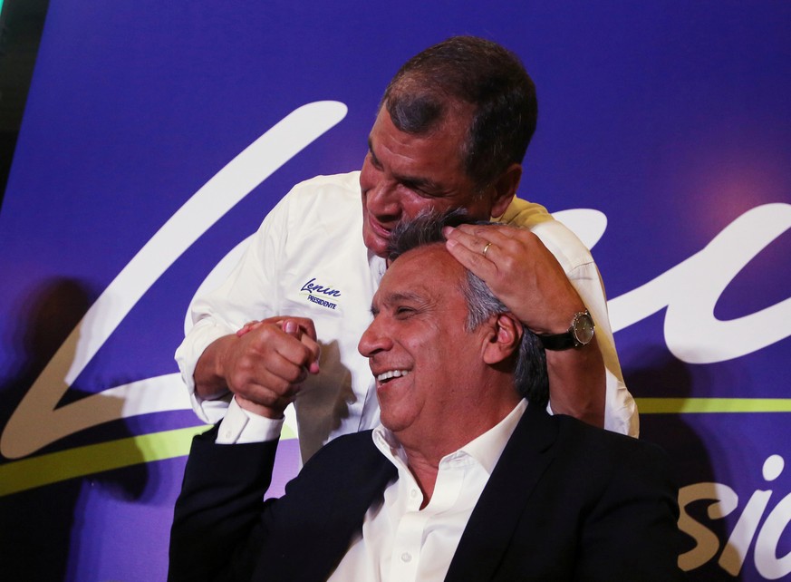 Ecuador's President Rafael Correa (top) hugs Lenin Moreno, candidate of the ruling PAIS Alliance Party, at the Hotel Colon during the presidential election in Quito, Ecuador February 19, 2017. RE ...