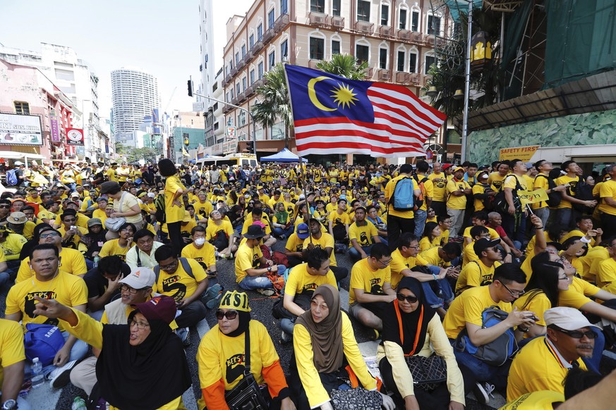 Protesters occupy a street during a rally in downtown Kuala Lumpur, Malaysia, Saturday, Nov. 19, 2016. Malaysian police detained 12 activists and tightened security ahead of the rally Saturday by elec ...