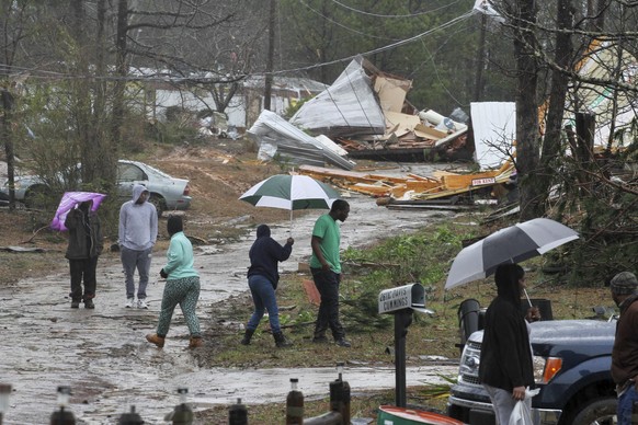 Residents in Lauderdale, Miss., wander through their neighborhood on Green Loop Road, Sunday, Jan. 22, 2017 after their homes were damaged by a tornado that hit late Saturday night. (Paula Merritt/The ...