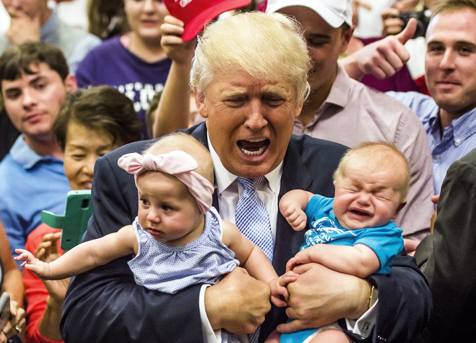 Republican presidential candidate Donald Trump holds baby cousins Evelyn Kate Keane, 6 months old, and Kellen Campbell, 3 months old, following his speech Friday, July 29, 2016, in Colorado Springs, C ...