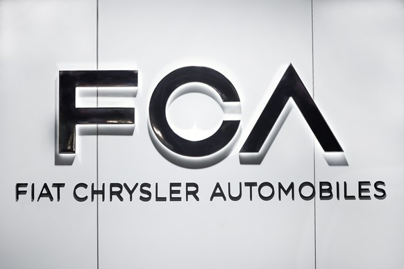 FILE - In this Monday, Jan. 14, 2019 file photo, Fiat Chrysler Automobiles FCA logo is shown at the North American International Auto Show in Detroit. Shares in Italian American automaker Fiat Chrysle ...